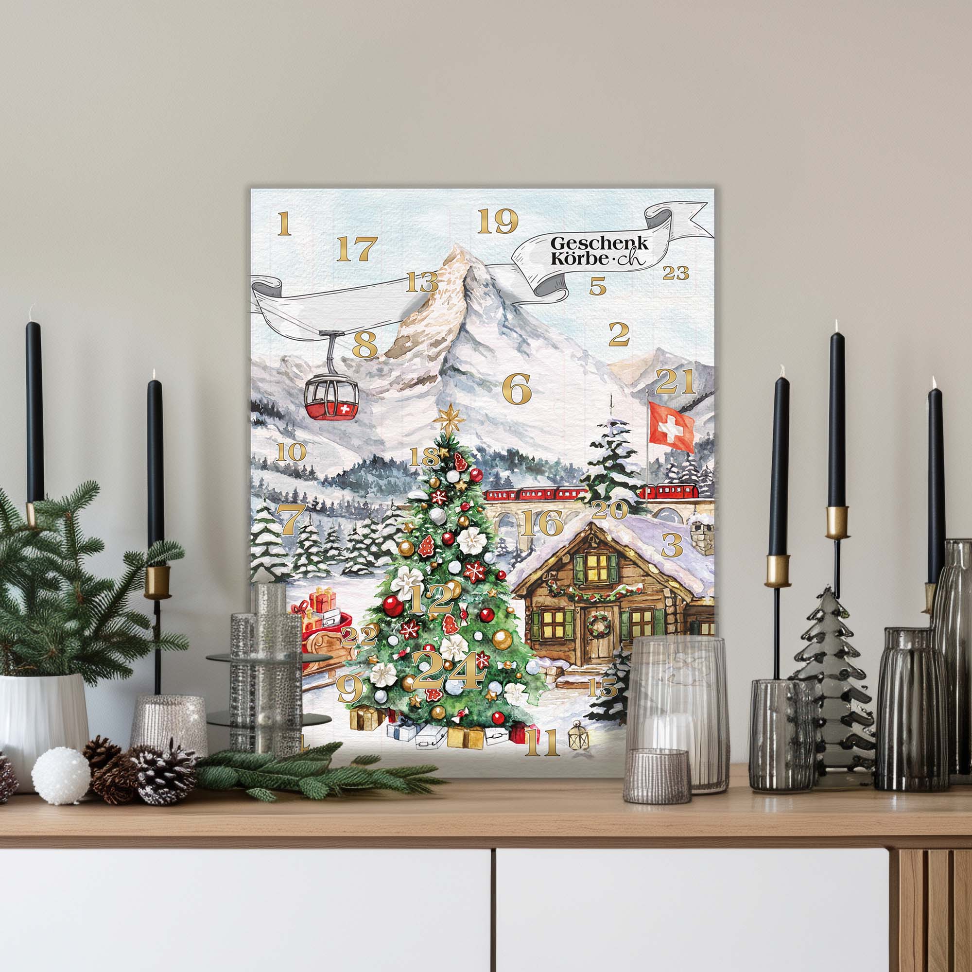 Adventskalender mit Schweizer Berglandschaft, Seilbahn, Zug und Weihnachtsbaum, versehen mit dem Logo von GeschenkKörbe.ch.