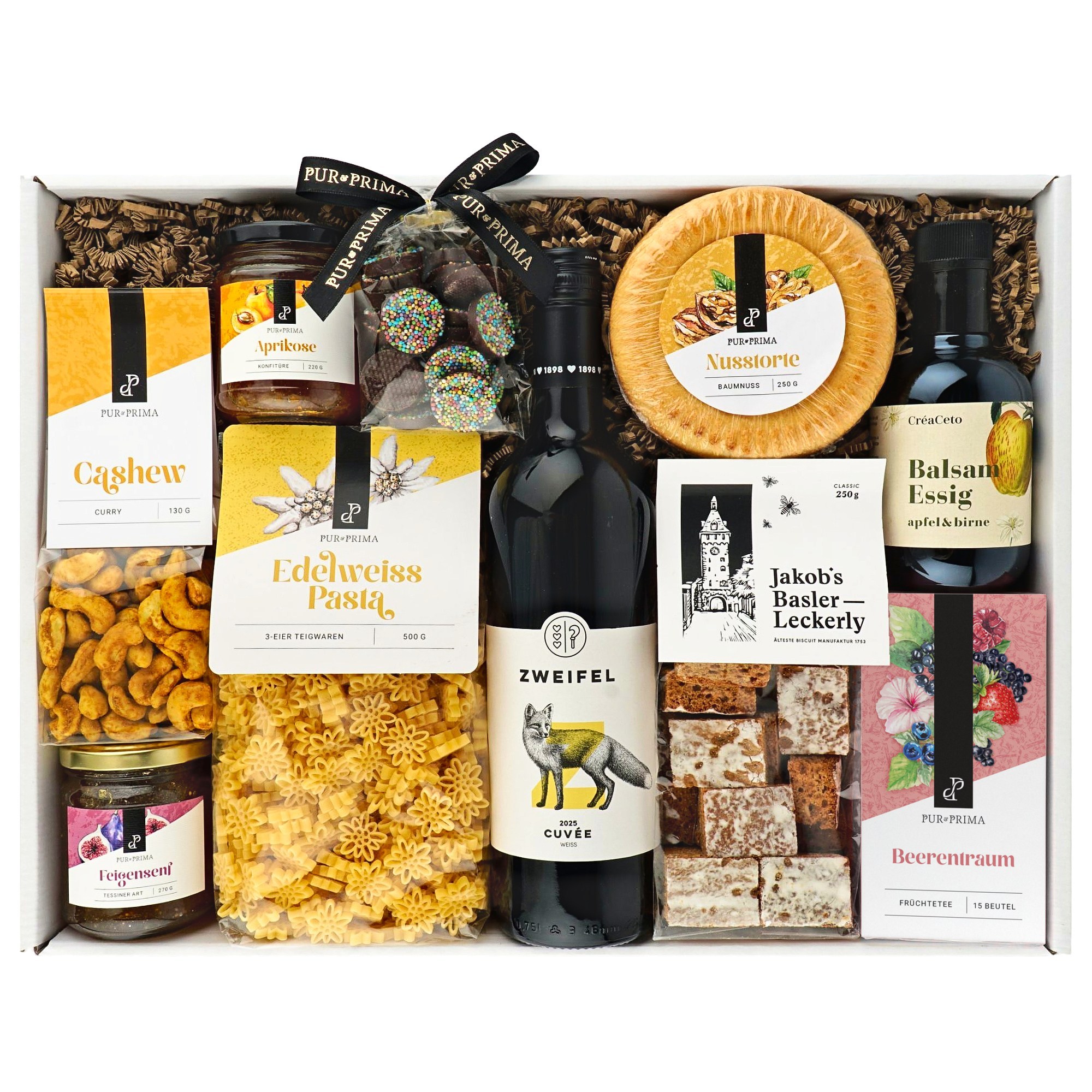 Geschenkbox mit Pur & Prima Aprikosenmarmelade, Curry-Cashewkernen, Edelweißnudeln, Nusstorte, Früchtetee, Essig und Wein.